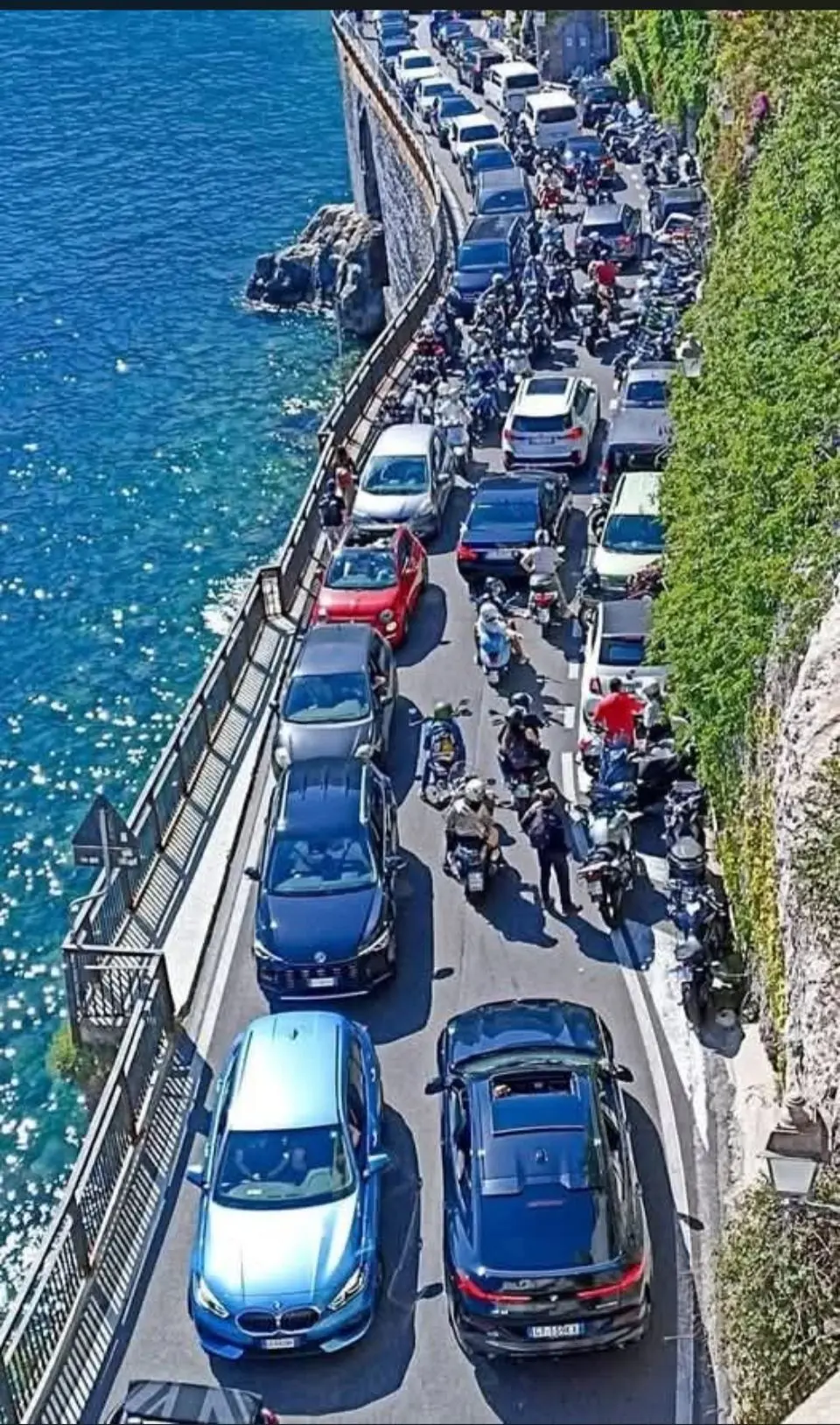 Amalfi Coast traffic narrow road with cars and scooters
